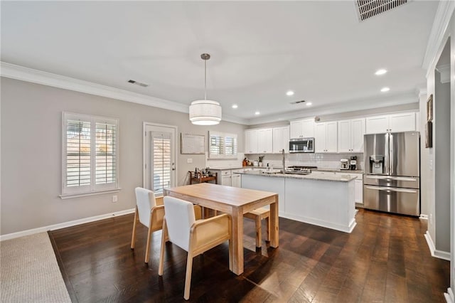 dining space featuring ornamental molding and dark hardwood / wood-style floors