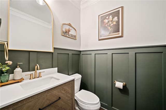 bathroom featuring vanity, ornamental molding, and toilet