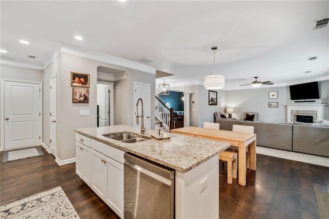 kitchen featuring sink, white cabinetry, dishwasher, pendant lighting, and a kitchen island with sink