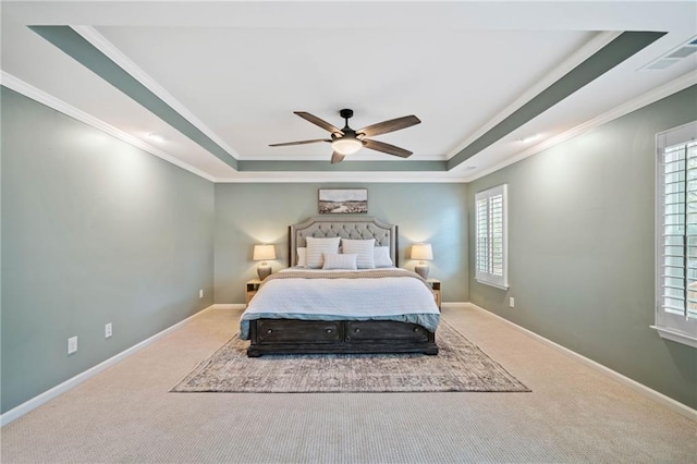 bedroom featuring ceiling fan, ornamental molding, a raised ceiling, and carpet