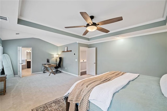 bedroom with crown molding, ceiling fan, connected bathroom, a tray ceiling, and light carpet