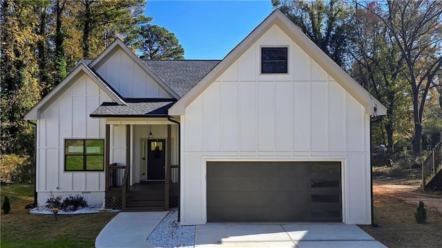 modern farmhouse style home featuring driveway, a shingled roof, a garage, and board and batten siding