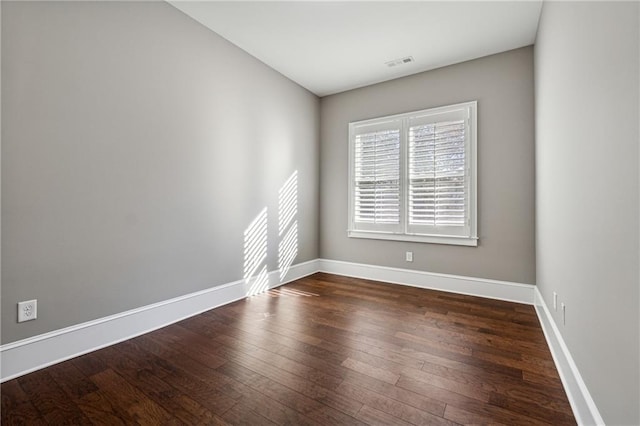 unfurnished room featuring dark hardwood / wood-style floors