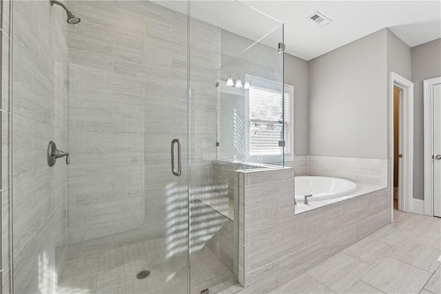 bathroom featuring tile patterned flooring and separate shower and tub