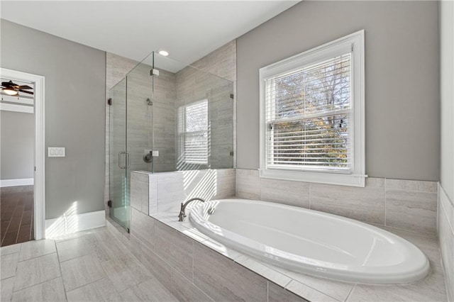 bathroom with tile patterned floors, a wealth of natural light, ceiling fan, and independent shower and bath