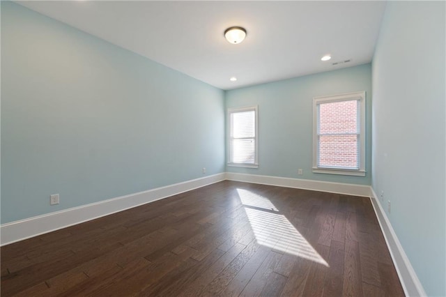 empty room featuring dark wood-type flooring