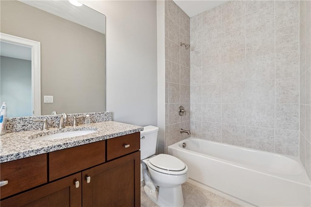 full bathroom with vanity, tile patterned flooring, tiled shower / bath, and toilet