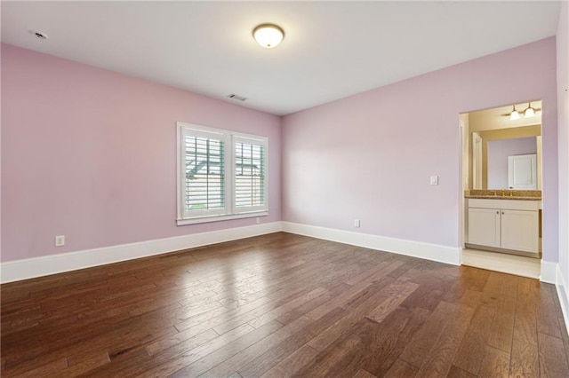 unfurnished room with dark wood-type flooring