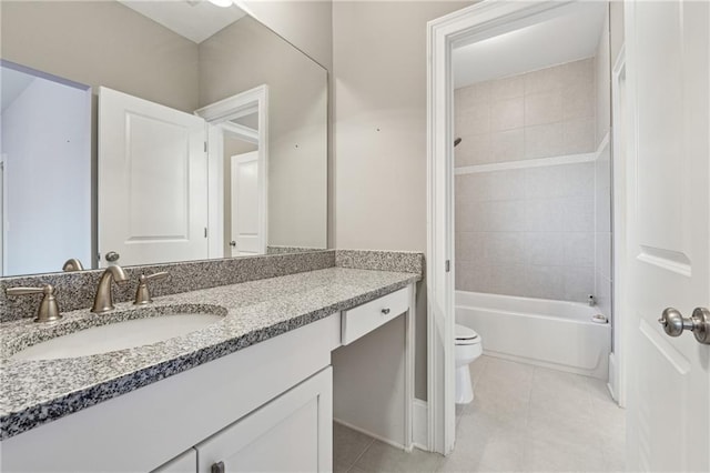 full bathroom with tile patterned floors, tiled shower / bath, vanity, and toilet