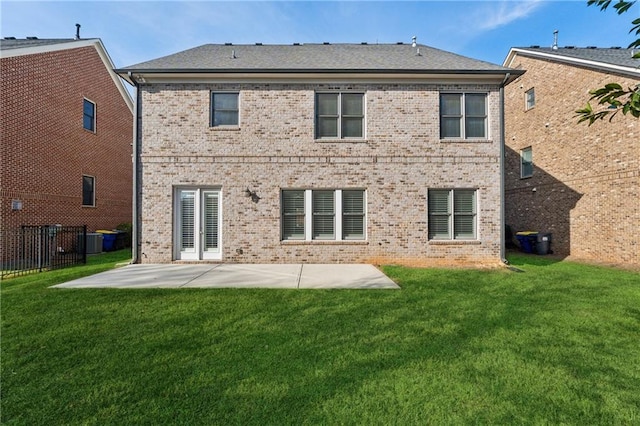 back of property with a yard, central AC unit, and a patio area