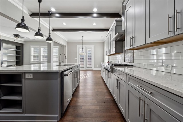 kitchen with beam ceiling, gray cabinets, light stone counters, and sink