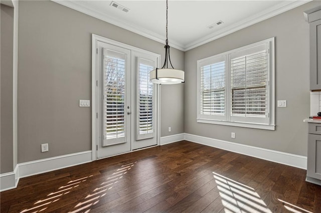 unfurnished dining area with french doors, dark wood-type flooring, crown molding, and a healthy amount of sunlight