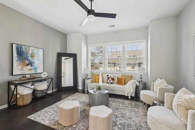 living room featuring ceiling fan and dark wood-type flooring