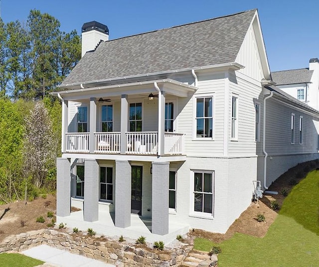 back of house featuring a balcony and ceiling fan