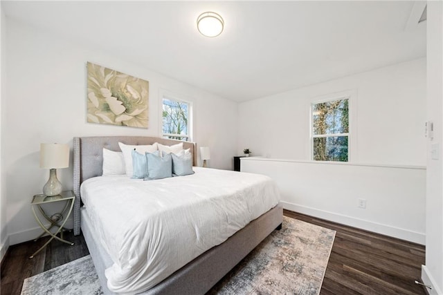 bedroom with wood finished floors and baseboards