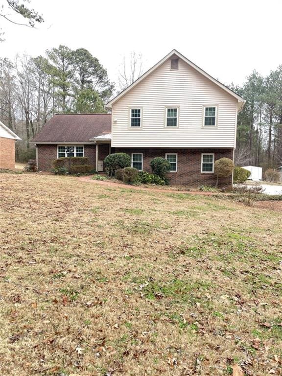 rear view of house with a lawn