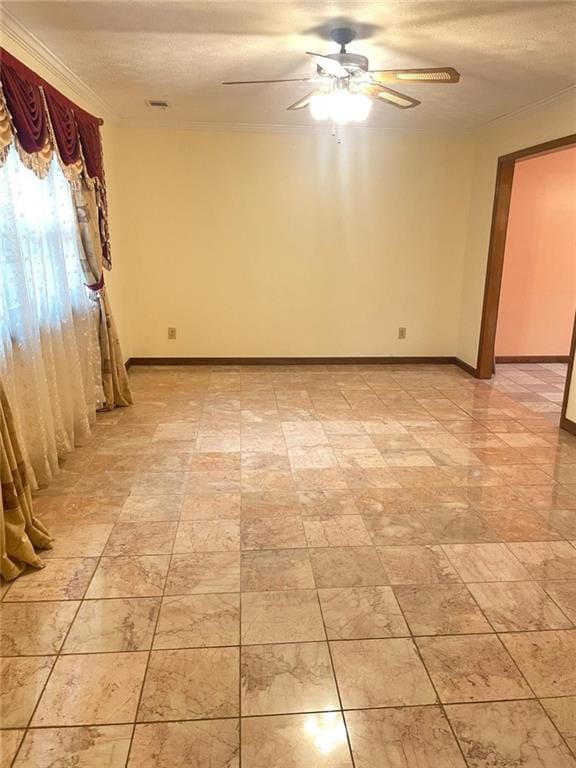 empty room with ceiling fan and a textured ceiling