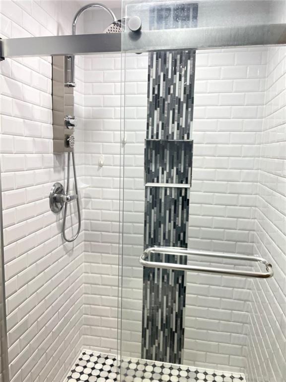 bathroom featuring a shower with door