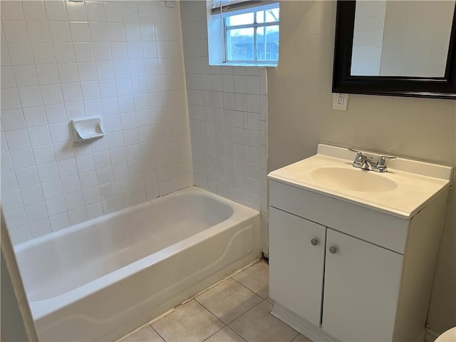 bathroom with vanity, tiled shower / bath combo, and tile patterned flooring