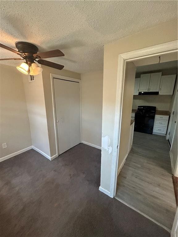 interior space featuring ceiling fan and a textured ceiling