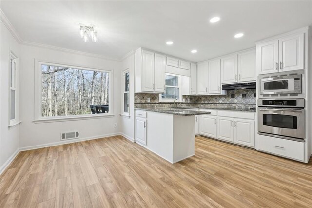 unfurnished living room with ceiling fan and light hardwood / wood-style floors