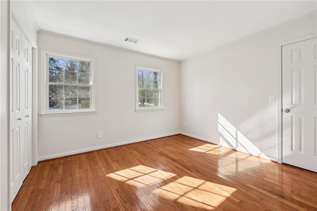 unfurnished bedroom featuring hardwood / wood-style flooring and ornamental molding