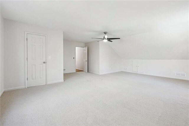 unfurnished sunroom with a wall unit AC, a skylight, and ceiling fan