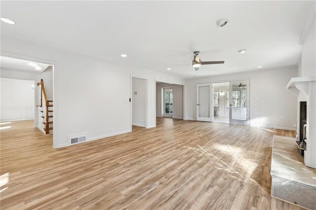 empty room with a notable chandelier, light hardwood / wood-style flooring, and crown molding