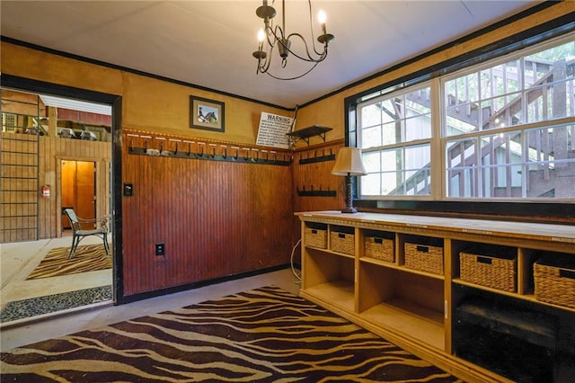 interior space with concrete floors, an inviting chandelier, and wood walls