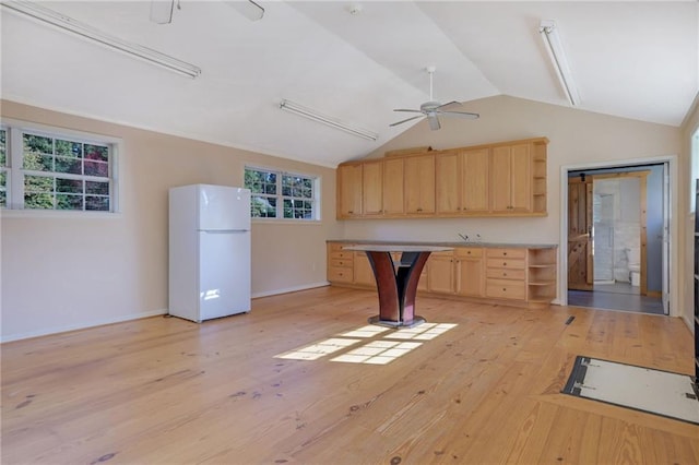 kitchen featuring lofted ceiling, light hardwood / wood-style flooring, ceiling fan, light brown cabinetry, and white fridge