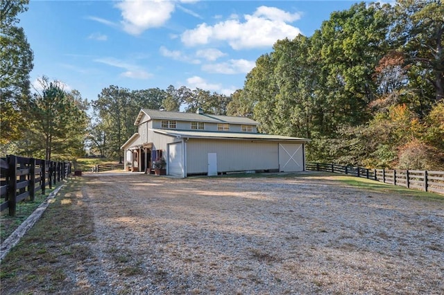 view of side of property featuring an outbuilding