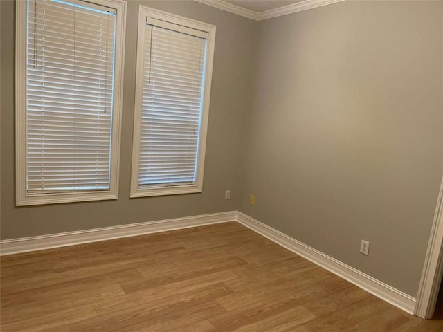 unfurnished room with crown molding and light hardwood / wood-style floors