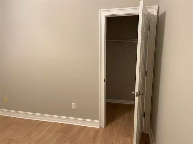 unfurnished bedroom featuring a closet and light hardwood / wood-style flooring