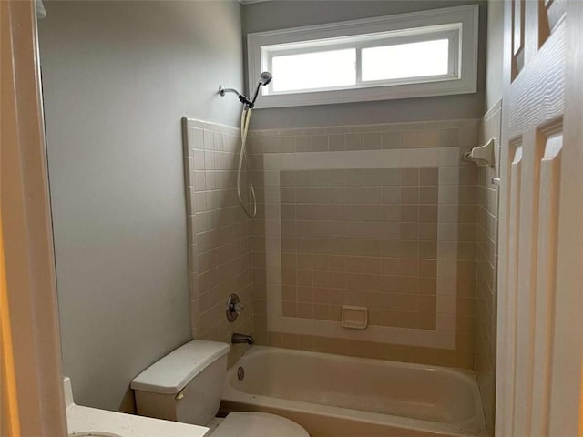 full bathroom featuring vanity, toilet, and tiled shower / bath