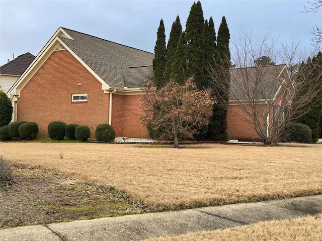 view of side of home featuring a lawn