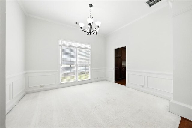 12554 Huntington Trce, Alpharetta, GA 30005 - carpeted empty room with a chandelier, ornamental molding, a wainscoted wall, and a decorative wall