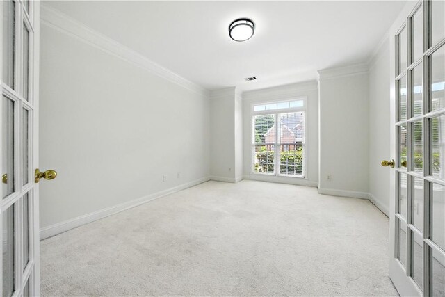 12554 Huntington Trce, Alpharetta, GA 30005 - spare room featuring french doors, crown molding, carpet floors, and baseboards