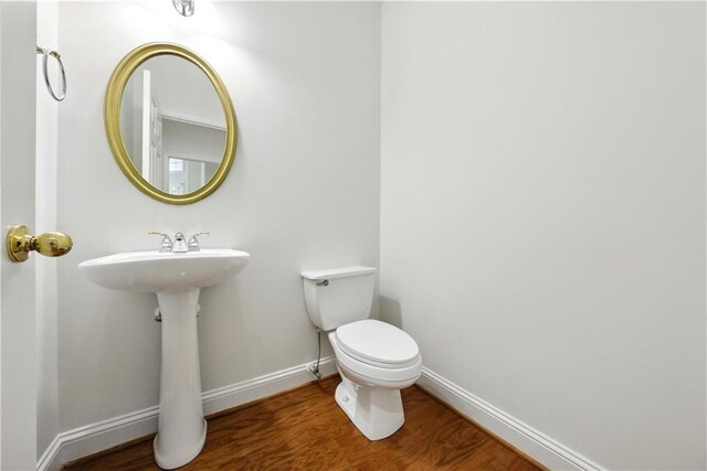 12554 Huntington Trce, Alpharetta, GA 30005 - bathroom with wood finished floors, toilet, baseboards, and a sink