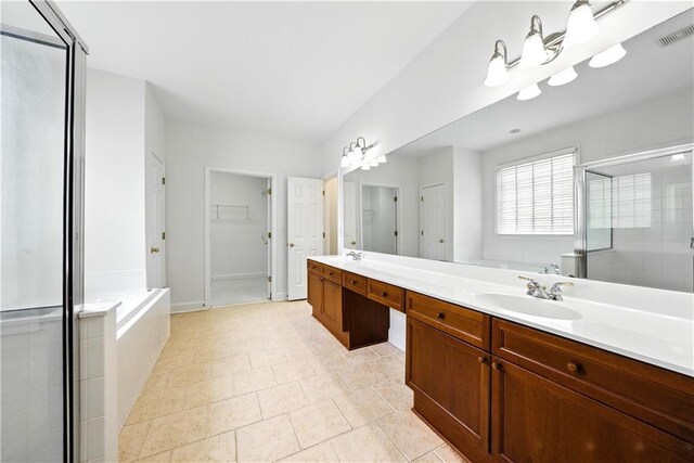12554 Huntington Trce, Alpharetta, GA 30005 - bathroom with a shower stall, double vanity, a bath, a spacious closet, and tile patterned floors