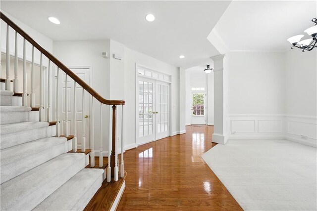 12554 Huntington Trce, Alpharetta, GA 30005 - entrance foyer featuring stairs, wood finished floors, a chandelier, wainscoting, and recessed lighting