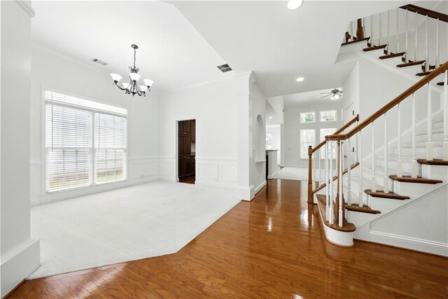 12554 Huntington Trce, Alpharetta, GA 30005 - foyer featuring arched walkways, a chandelier, stairway, wood finished floors, and ceiling fan