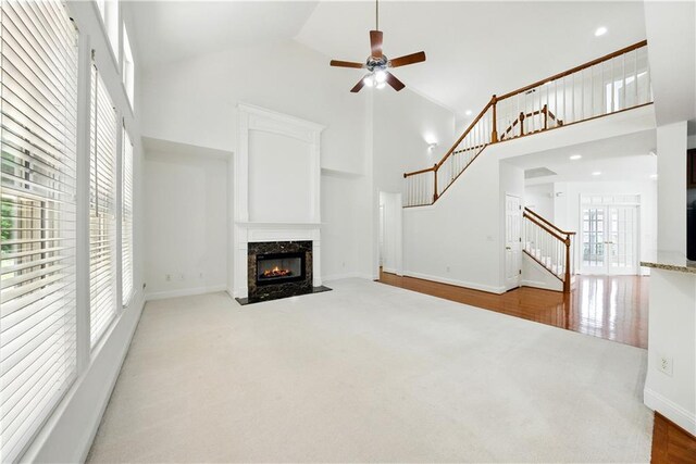 12554 Huntington Trce, Alpharetta, GA 30005 - unfurnished living room featuring high vaulted ceiling, stairway, a premium fireplace, carpet, and a ceiling fan