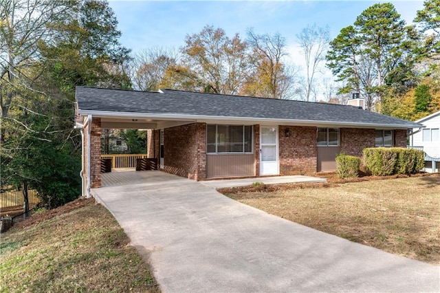 ranch-style home featuring a carport and a front yard