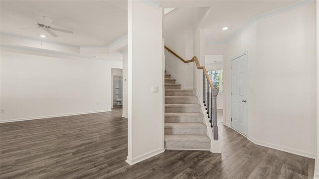 1149 Blue Juniper Cir, Loganville, GA 30052 - foyer with dark wood-type flooring, stairway, baseboards, ceiling fan, and crown molding