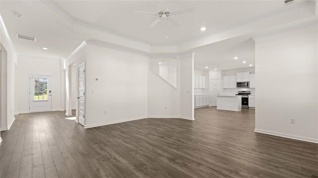 1149 Blue Juniper Cir, Loganville, GA 30052 - unfurnished living room featuring crown molding, a ceiling fan, dark wood finished floors, baseboards, and recessed lighting