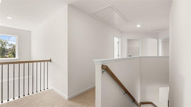 1149 Blue Juniper Cir, Loganville, GA 30052 - hallway with an upstairs landing, attic access, carpet flooring, baseboards, and recessed lighting