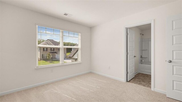 1149 Blue Juniper Cir, Loganville, GA 30052 - unfurnished bedroom with light carpet, baseboards, and ensuite bathroom