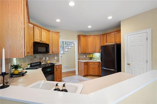 223 Oak Grove Dr, Dallas, GA 30157 - kitchen featuring black appliances, a sink, tasteful backsplash, light countertops, and recessed lighting