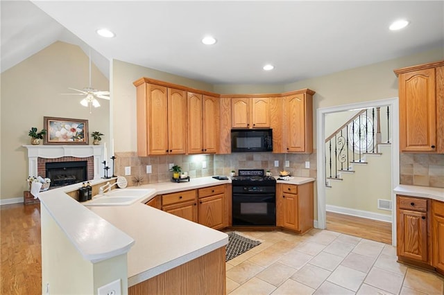 223 Oak Grove Dr, Dallas, GA 30157 - kitchen with gas range, black microwave, a ceiling fan, a peninsula, and a sink