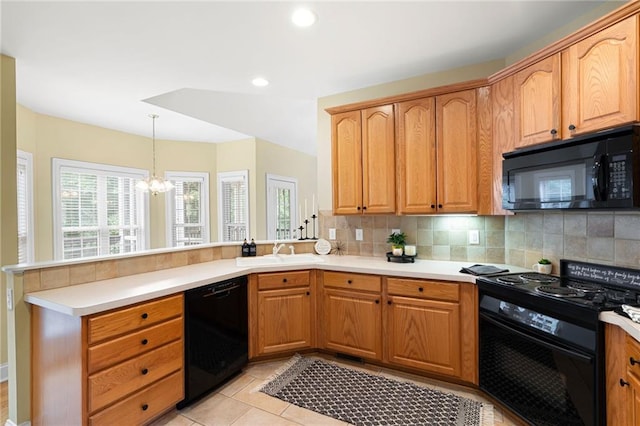 223 Oak Grove Dr, Dallas, GA 30157 - kitchen featuring black appliances, a sink, a peninsula, a chandelier, and tasteful backsplash